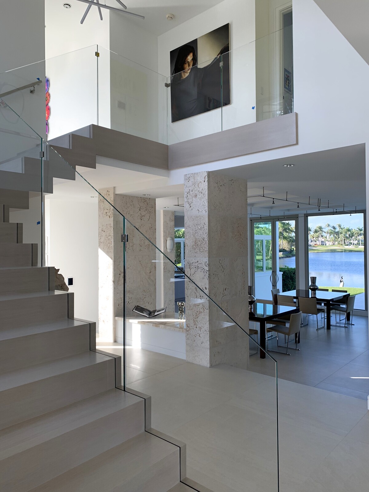 Custom frameless glass stair and second-floor railing in a South Florida waterfront home